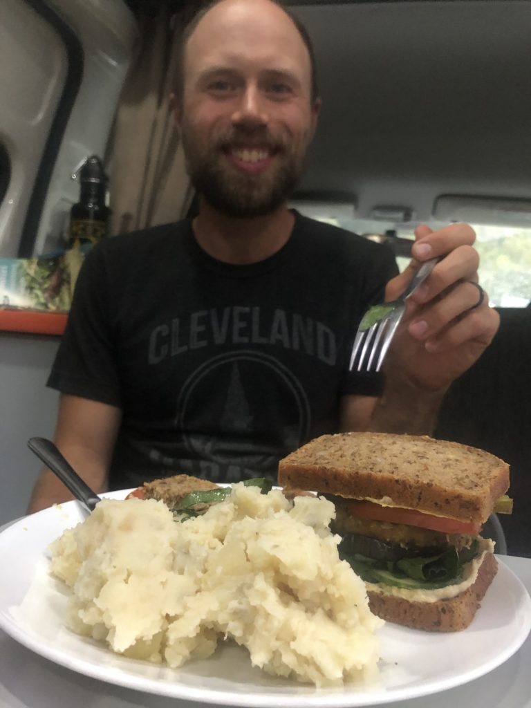 Vegan burgers with a side of mashed potatoes. Vegan meal made while traveling.