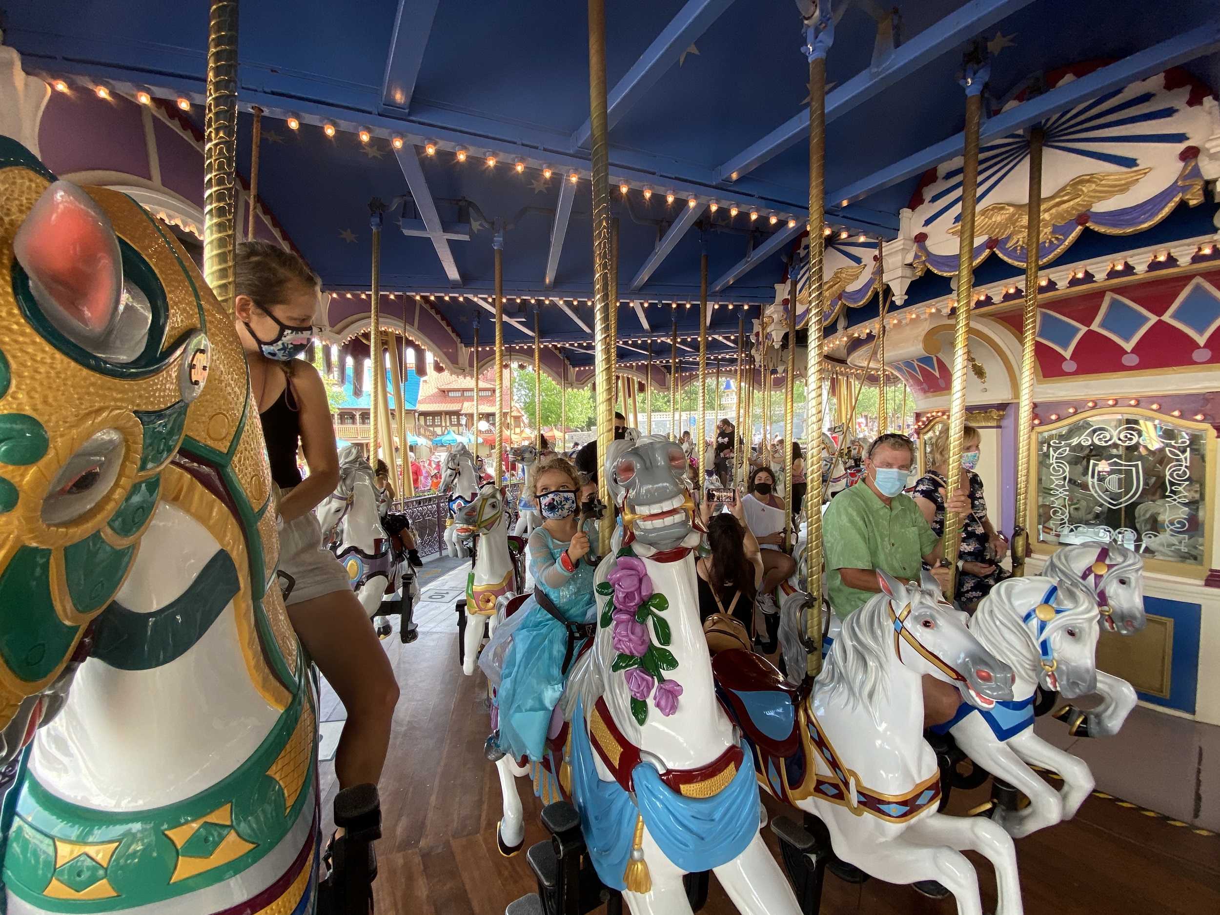 Family riding the Carousel in Magic Kingdom with a toddler