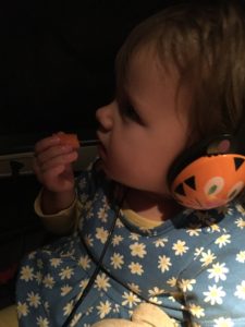 Toddler wearing headphones on a road trip