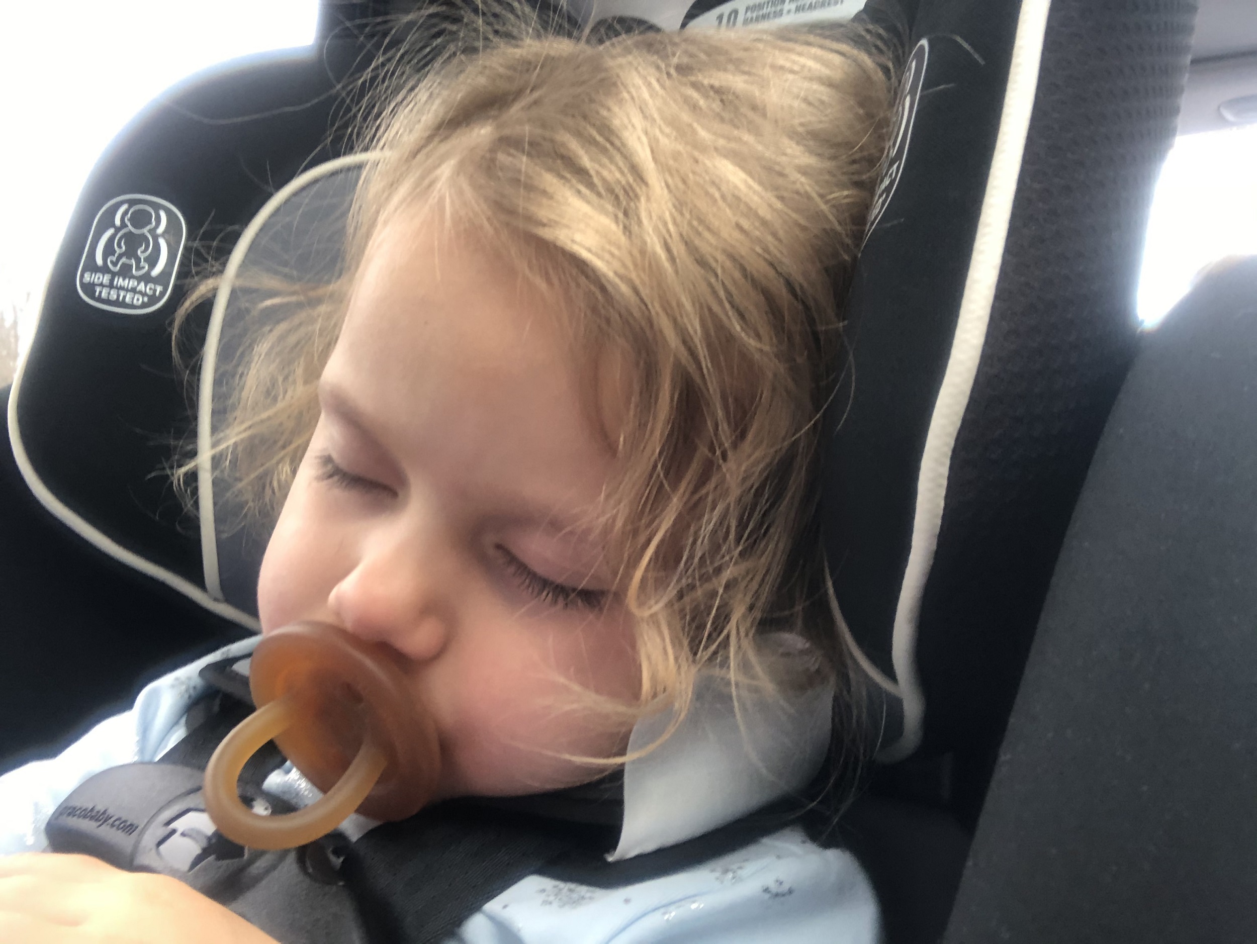 Toddler taking a nap on a road trip