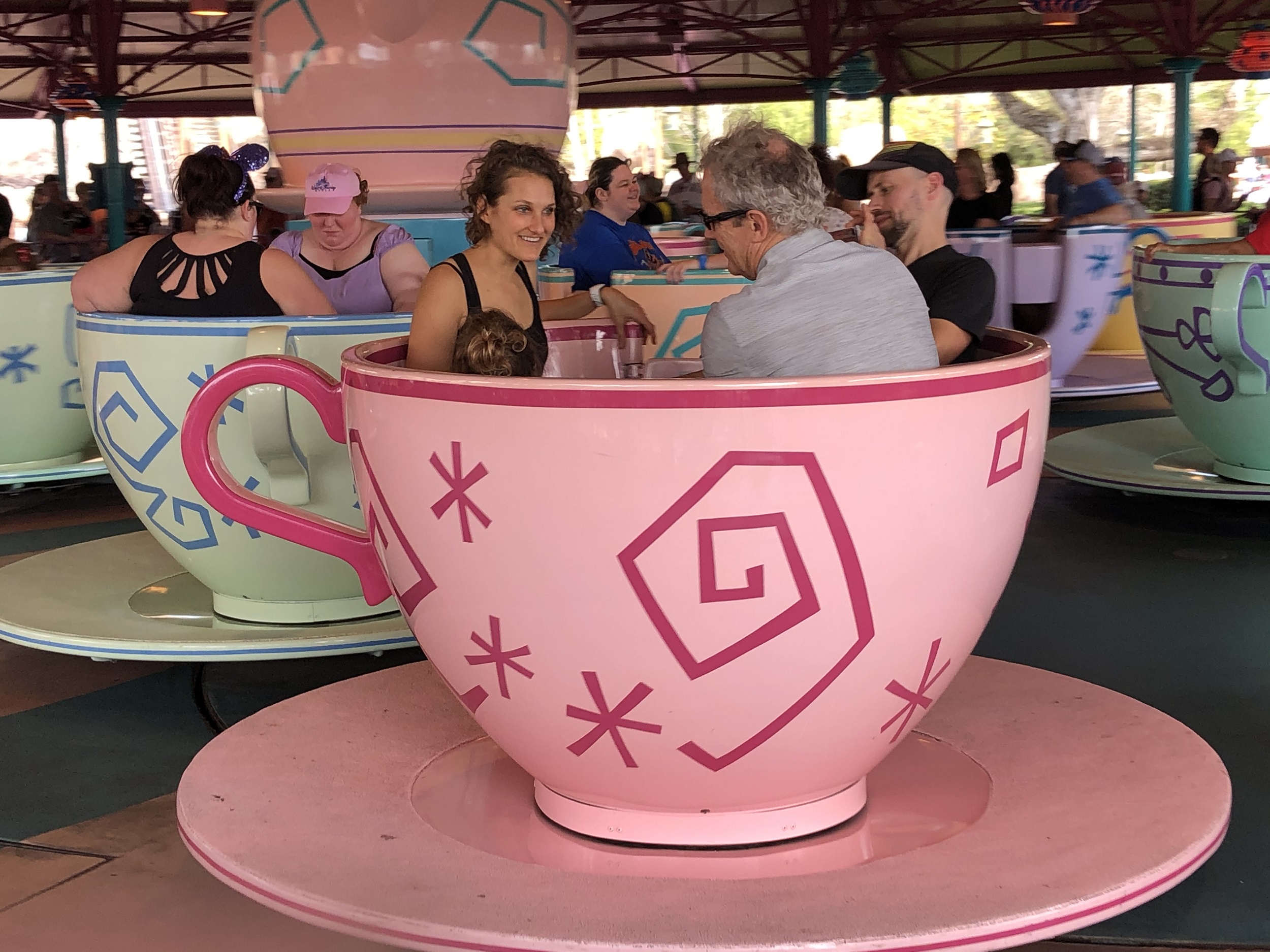 4 year old and her family riding the teacups in Disney World