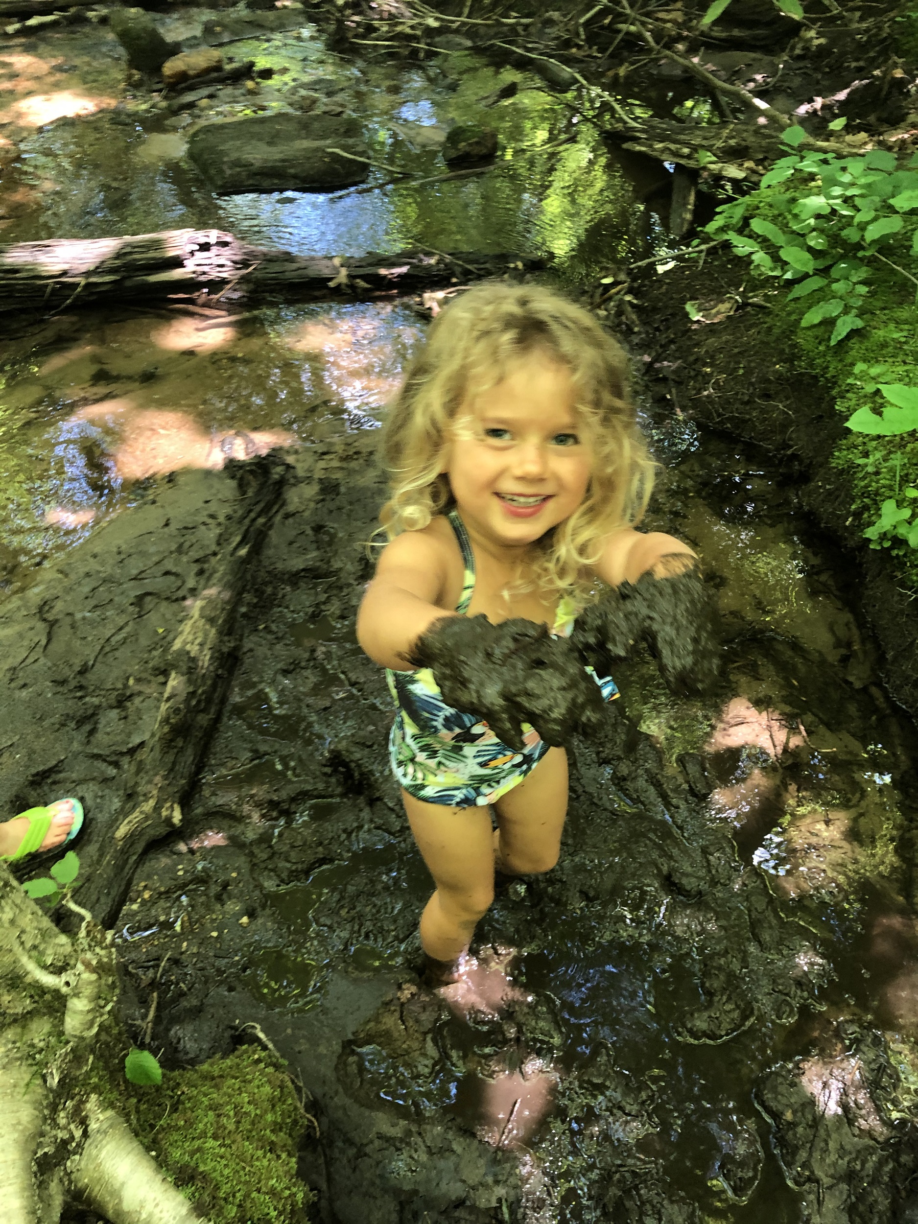 Child getting dirty on a hike