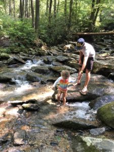 Child playing in the creek on a hike in Boone NC