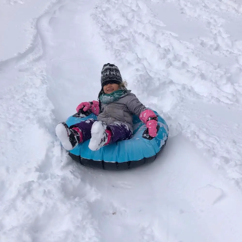 Child sledding in winter in Boone NC