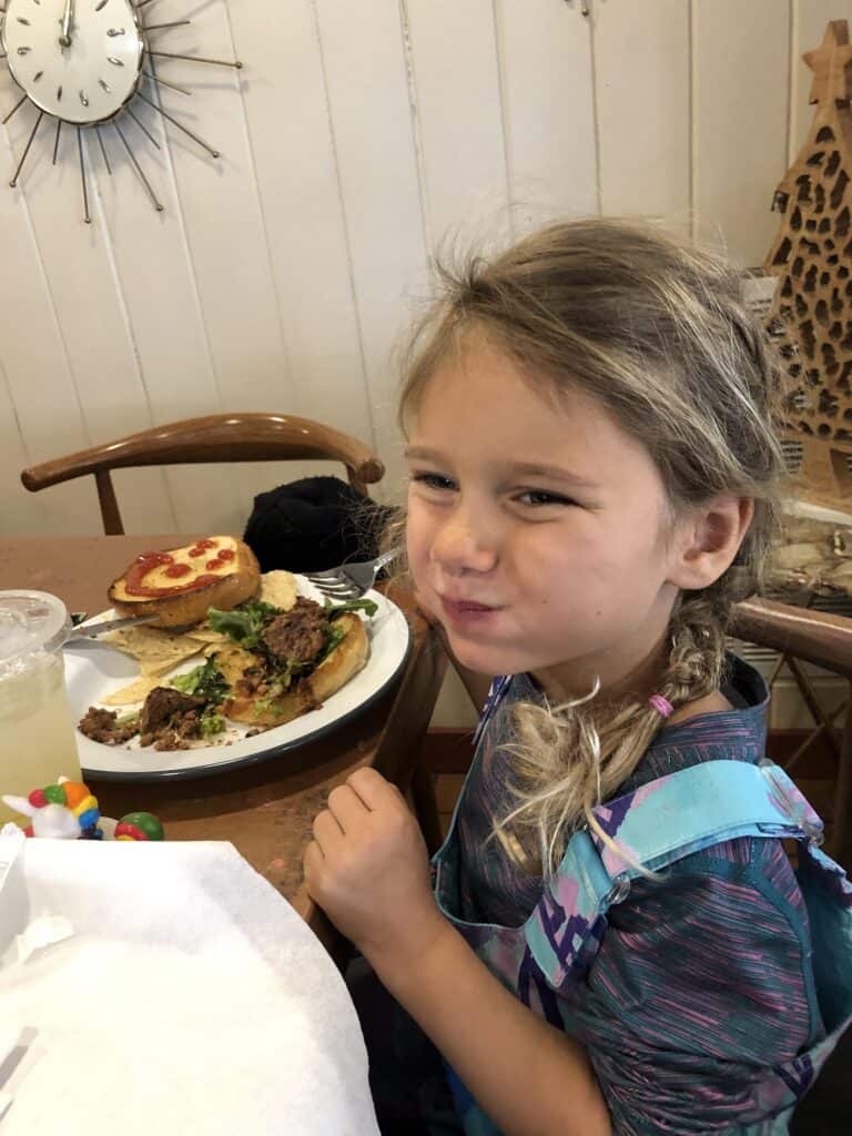 girl eating a burger for vegan food in boone nc at wildcraft eatery