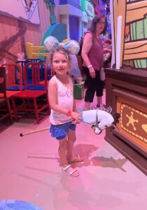 Child riding in on a horse to Roundup Rodeo BBQ at Disney World