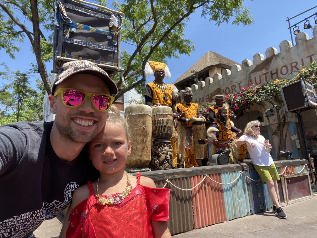 Father and daughter enjoying African drummers in Animal Kingdom