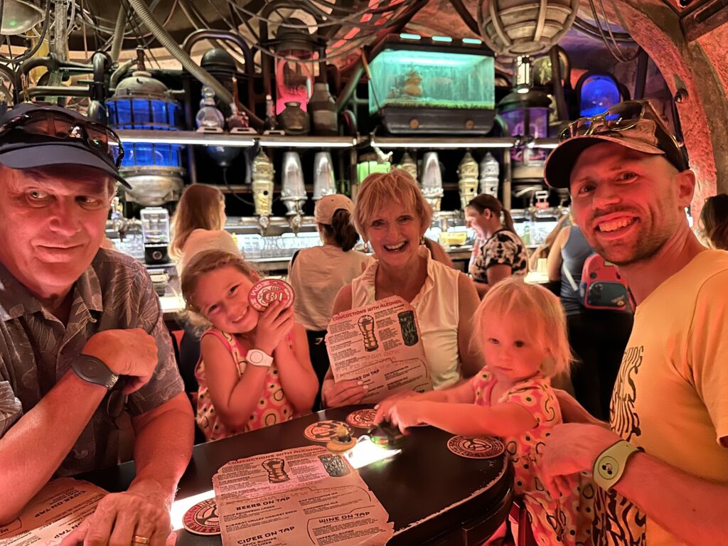 Family having drinks at a standing table at Oga's Cantina in Disney World
