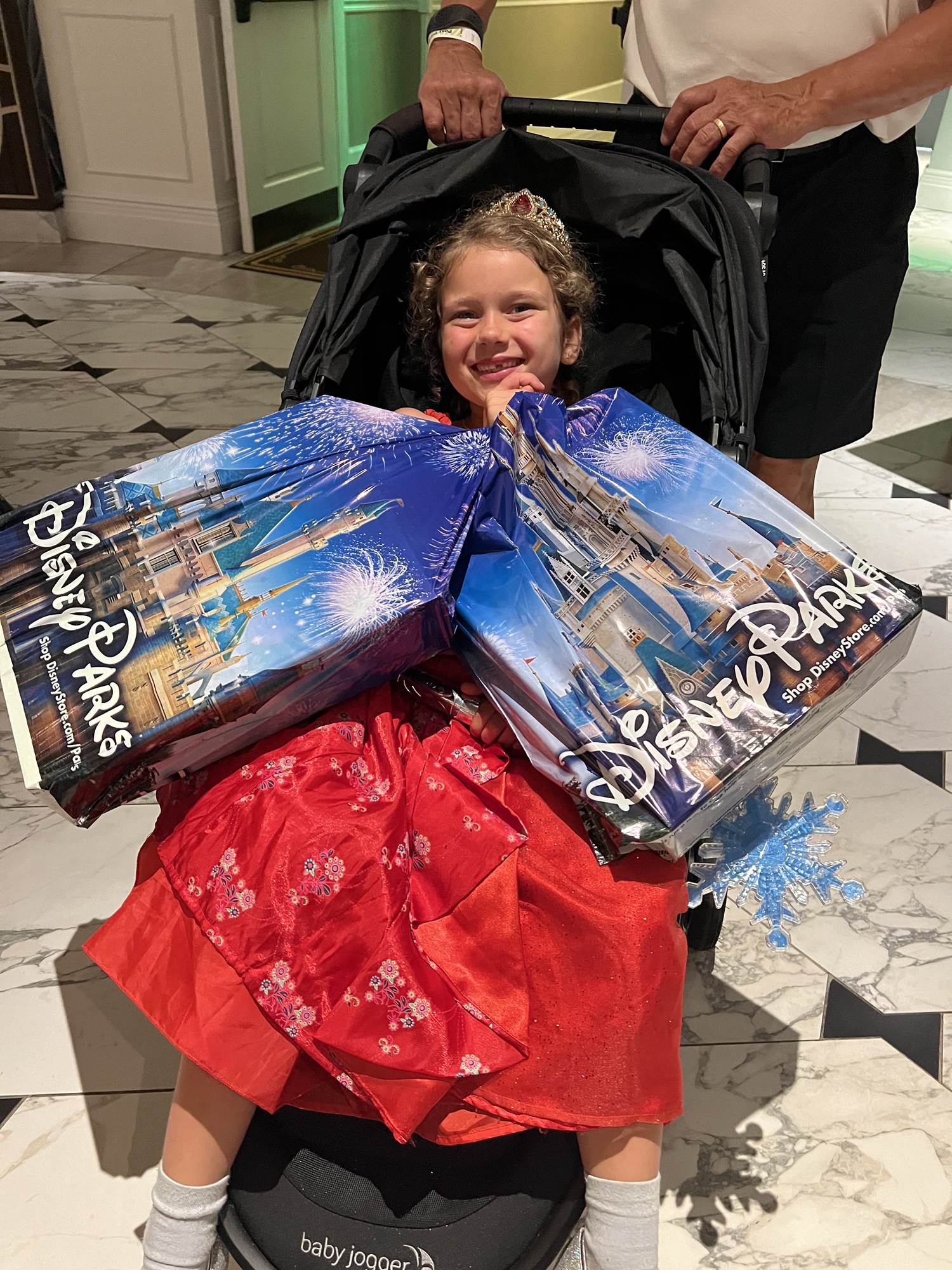 Child holding souvenirs in Disney World