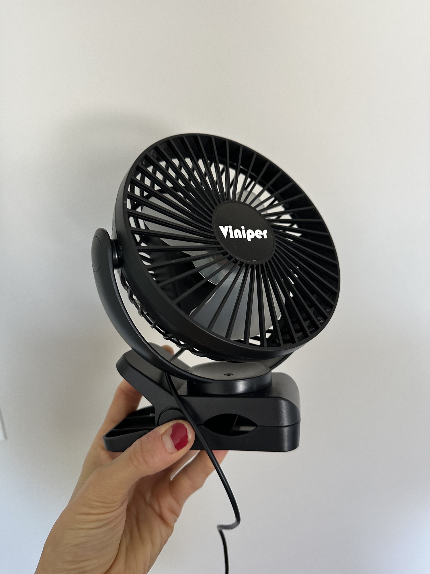 A portable fan like this one with a clip is perfect for staying cool at the beach