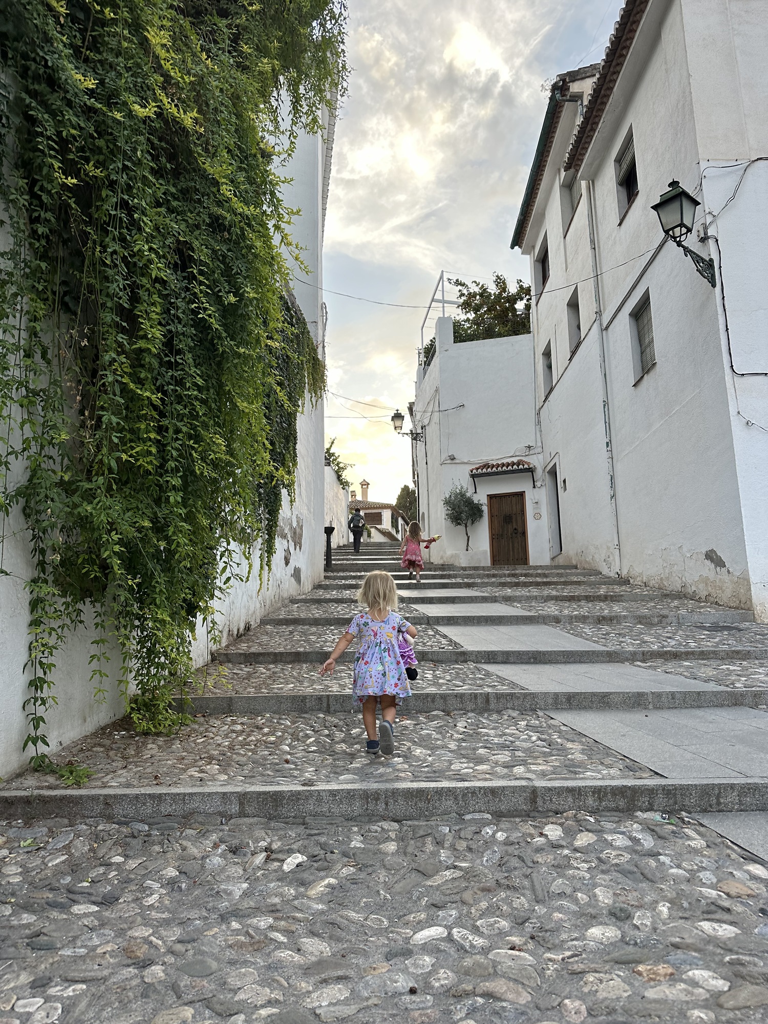 Child climbing steps in Granada