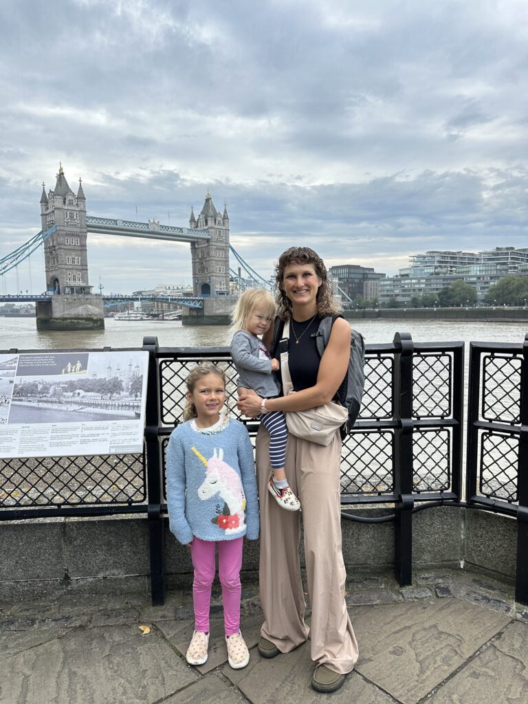 Mother wearing Lems Waterproof shoes in London with kids in front of Tower Bridge