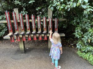 Child playing with music element at a free playground in London