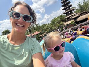 Toddler and her mother riding Aladdin's flying carpet in magic kingdom