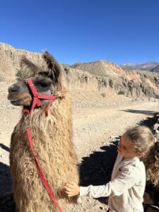 A girl with a llama in Tilcara, Argentina
